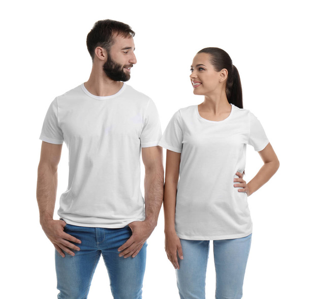 Young couple in t-shirts on white background. Mockup for design - Foto, Imagen