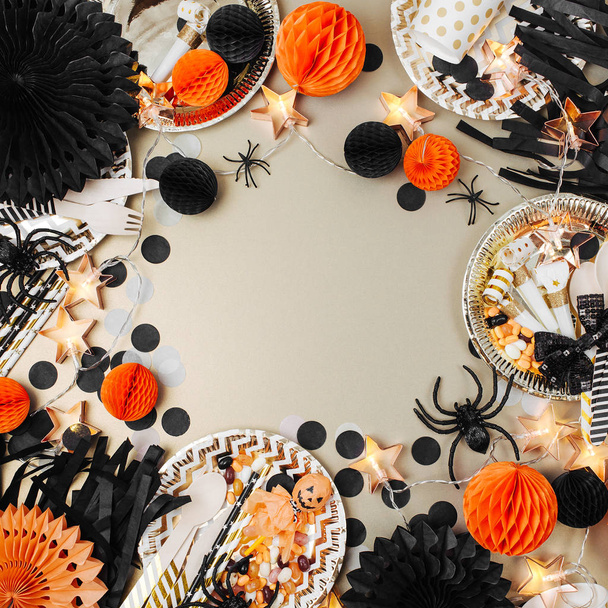 Halloween Table setting. Frame made of black and orange party decoration stuff. Flat lay, top view - Fotografie, Obrázek