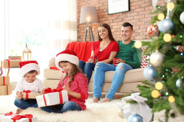 Happy parents and children celebrating Christmas together at home - Фото, зображення
