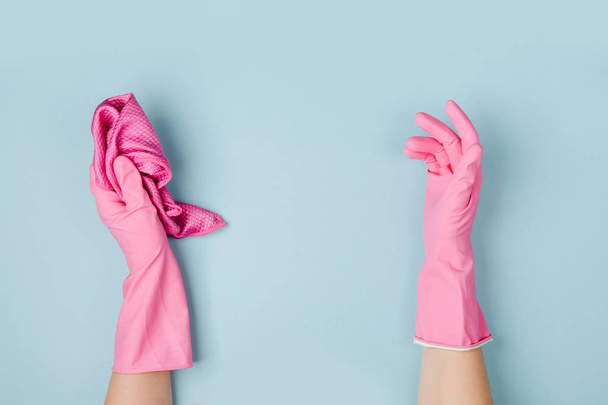 Female hands cleaning on blue background. Cleaning or housekeeping concept background. Copy space.  Flat lay, Top view. - Photo, Image