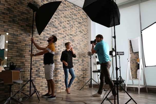 Professional team working with model in photo studio - Foto, afbeelding