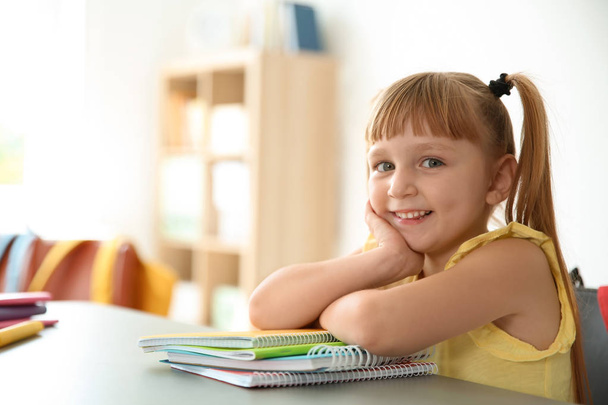 Cute little child sitting at desk in classroom. Elementary school - Zdjęcie, obraz