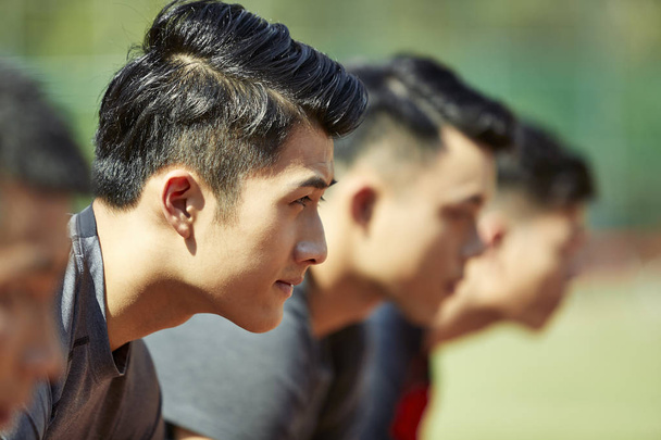 close-up of faces of young asian adult runners on starting line. - Foto, imagen