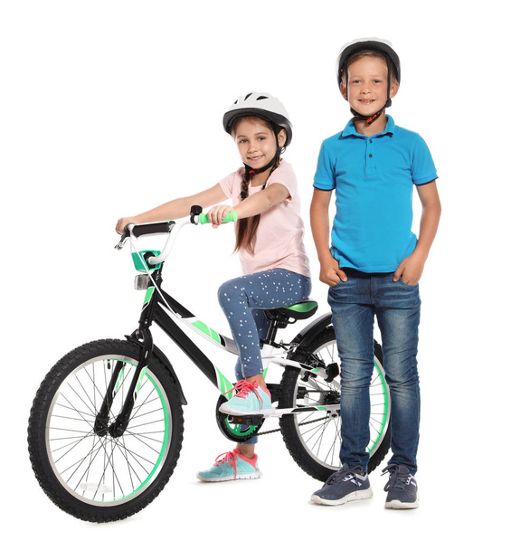 Portrait of cute little children with bicycle on white background - Foto, afbeelding