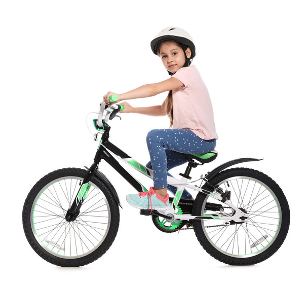 Portrait of cute little girl with bicycle on white background - Foto, Bild
