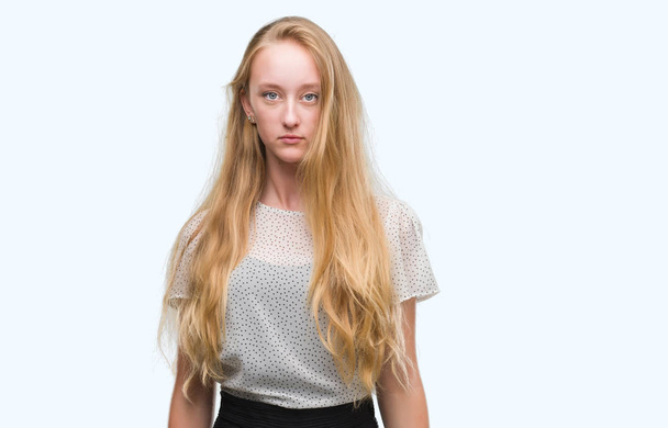 Kobieta blonde nastolatek koszulkę moli z poważną miną na twarzy. Proste i naturalne, patrząc na kamery. - Zdjęcie, obraz