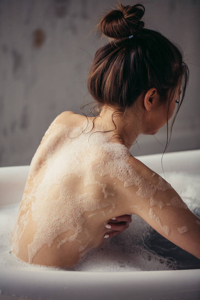 back view photo of woman who is leaving the bath - 写真・画像