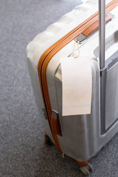 Close up of blank  luggage tag label on a suitcase  - Valokuva, kuva