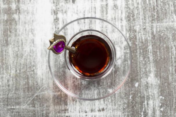 Red tea in turkish glass on a wooden table - Fotografie, Obrázek
