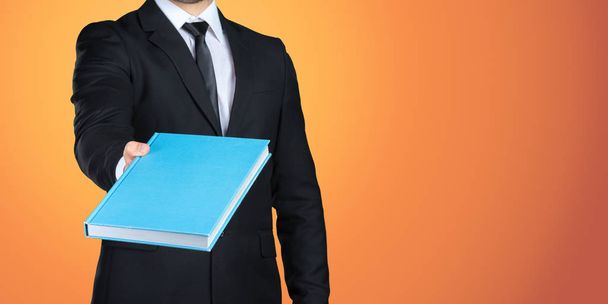 Unrecognizable businessman holding  a book - Фото, изображение