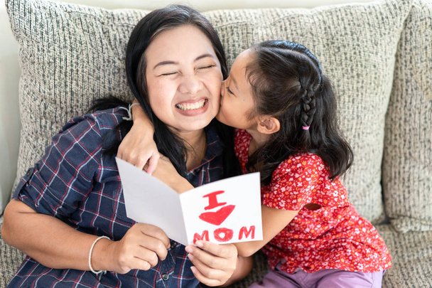 Κόρη δώσει μητέρα ημέρα ευχετήρια κάρτα με τη μαμά - Φωτογραφία, εικόνα