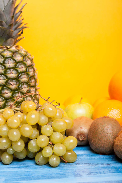 Mixed tasty fruit composition set on yellow background - Foto, imagen