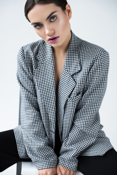 attractive girl posing in vintage elegant jacket, isolated on grey - Fotó, kép
