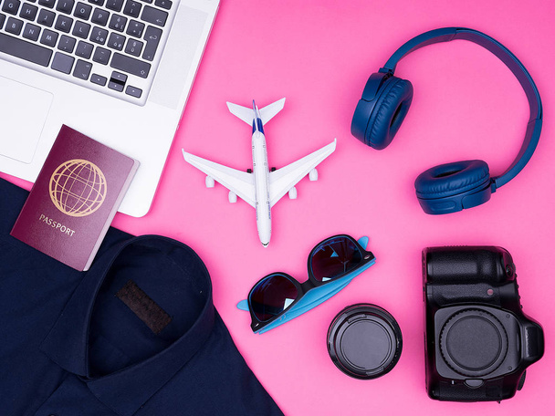 flat lay top view of traveler photographer accessories on pink background - 写真・画像