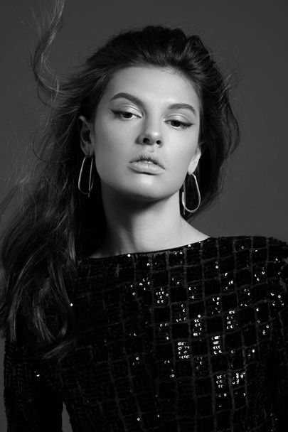 Black and white beauty portrait of young fashion model classic evening make up wearing stylish earrings - Photo, image