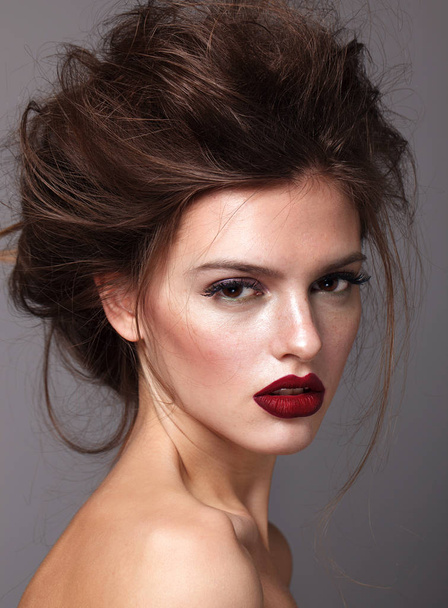 Portrait of beautiful glamorous brunette woman with bright make up and stylish hairdress. Red lips - Fotó, kép