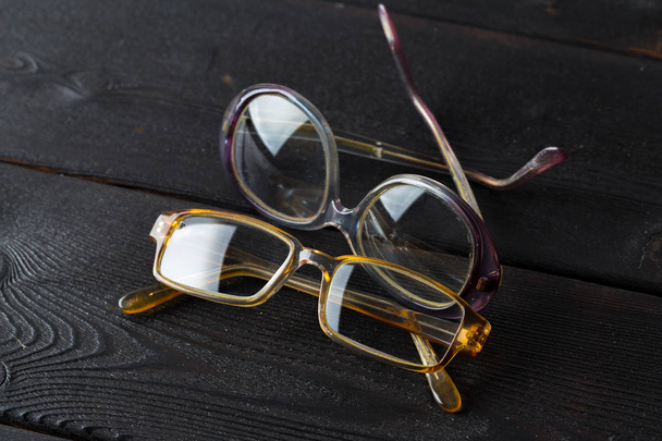 eyeglasses on black wooden table - Foto, Bild