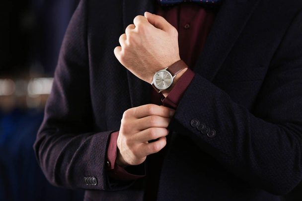 Young man in elegant suit on blurred background - Fotoğraf, Görsel