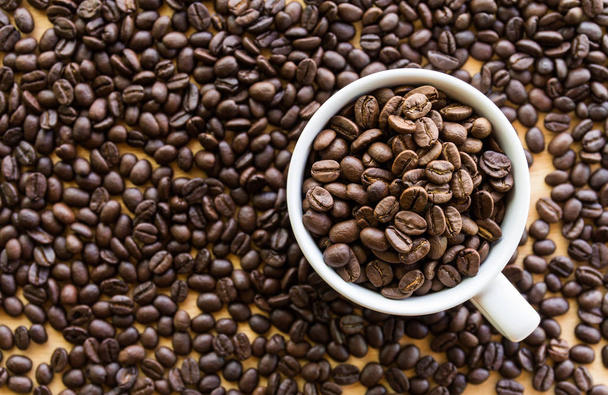Close up of white coffee cup full of coffee beans background with copy space - Foto, Bild