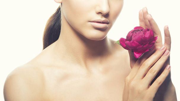 Cropped portrait of young woman with natural makeup and peony flower on white background - Φωτογραφία, εικόνα