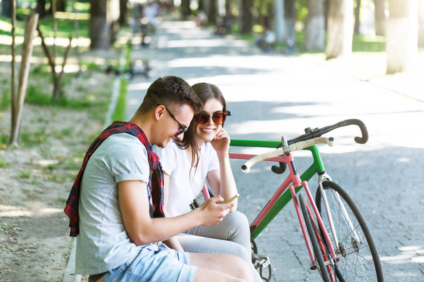 Couple With Bicycle Sitting On Beanch - Photo, image