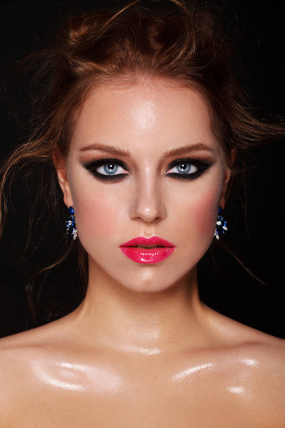 fashion portrait of attractive young female model with blue eyes and pink lips wearing luxury earrings - Фото, изображение