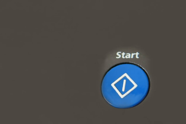 a blue start button on the black background - Photo, Image
