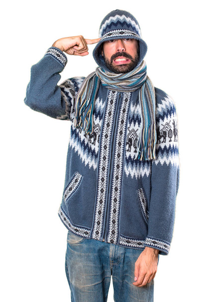 Man with winter clothes making crazy gesture - Фото, изображение