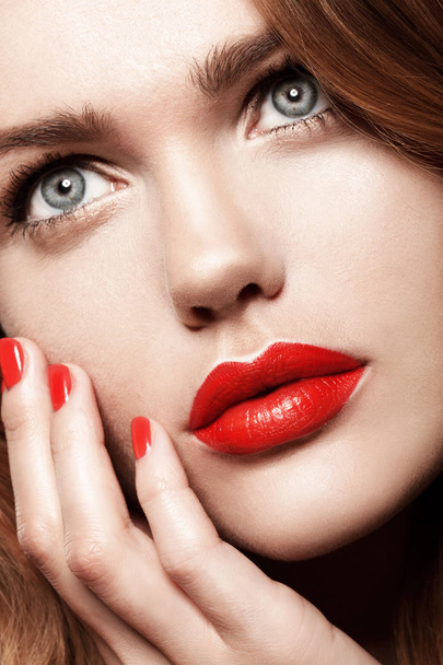 studio portrait of beautiful female model with red lips and wavy hair - Zdjęcie, obraz