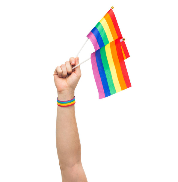 hand with gay pride rainbow flags and wristband - Фото, изображение