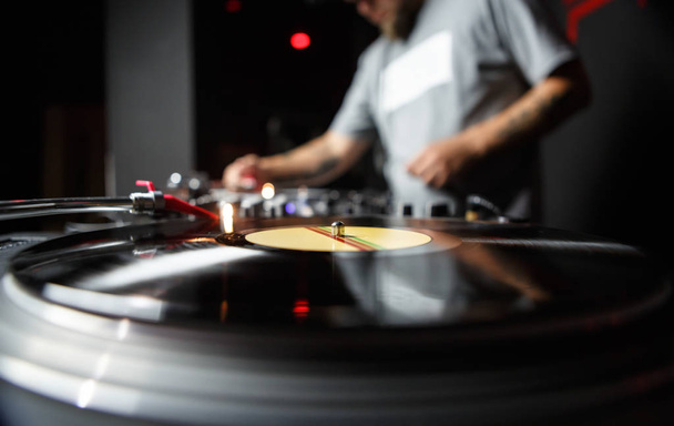 Professional dj turntable records player in close up. Disc jockey mixing music on background. Sound recording studio equipment  - Fotografie, Obrázek
