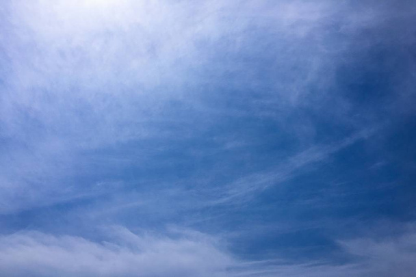 Beautiful clouds against a blue sky background. Cloud sky. Blue sky with cloudy weather, nature cloud. White clouds, blue sky and sun - Photo, Image