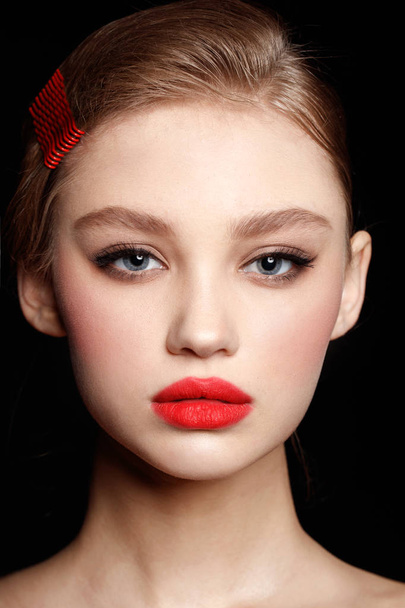 Beautiful teen model with red lips and fashion hairstyle on black background - Foto, Imagem