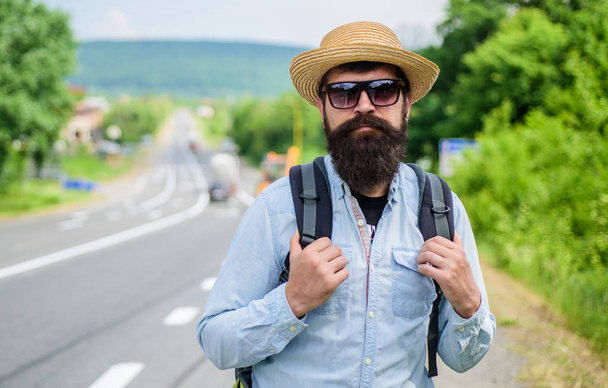 Look for fellow travelers. Tips of experienced backpacker. Man bearded hipster backpacker at edge of highway. Pick me up. Backpacker waiting for car take him anyway just to drop at better spot - Fotografie, Obrázek