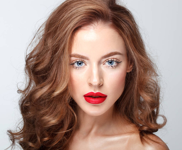 fashion portrait of beautiful brunette woman with blue eyes, bright red lips and long wavy hair - Фото, изображение