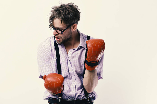 Competition and intelligent sport concept. Man with bristle and tired face wears boxing gloves - Foto, Bild