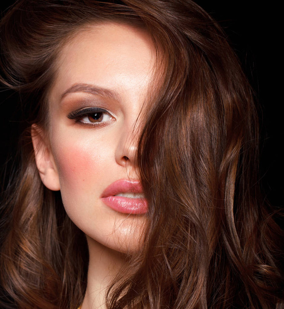 close up fashion portrait of sensual brunette woman with wavy hair on black studio background - Zdjęcie, obraz