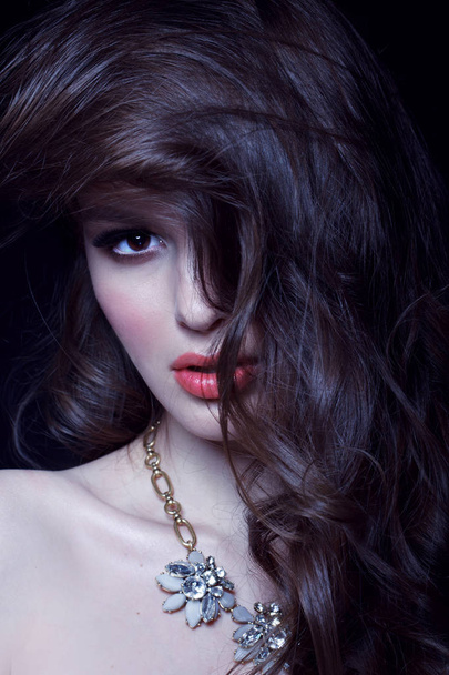 fashion portrait of sensual brunette woman with wavy hair on black studio background, toned - Foto, Imagem