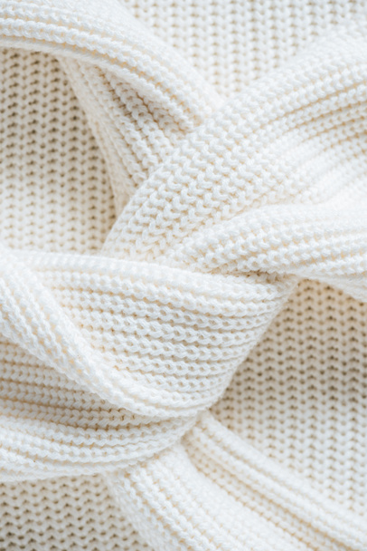 close up view of twisted sleeves of white woolen sweater  - Foto, imagen