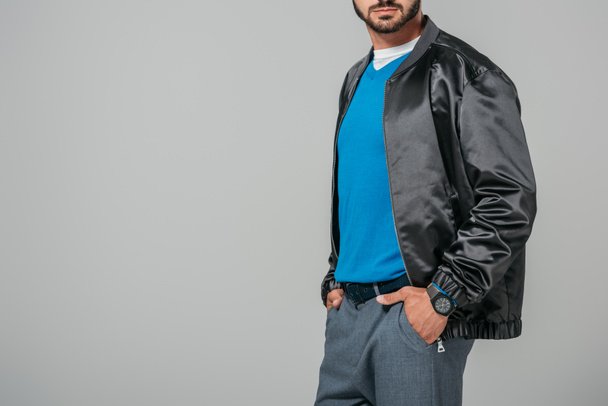 cropped image of man in stylish outfit posing with hands in pockets isolated on grey background  - Foto, Imagem