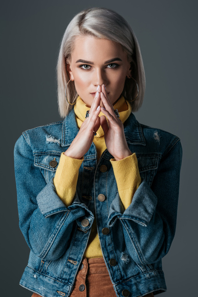 stylish woman in yellow turtleneck and jeans jacket, isolated on grey - Foto, immagini