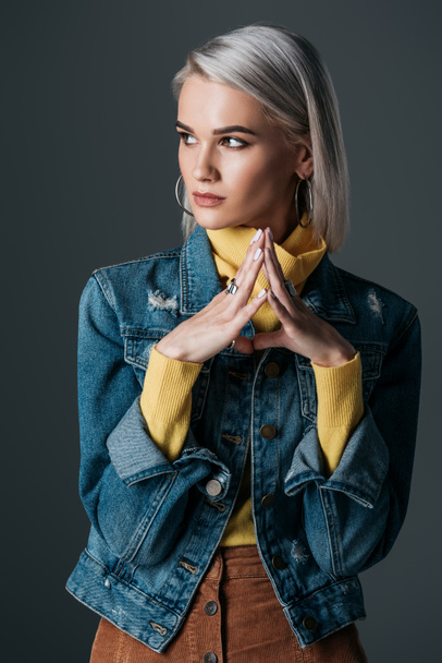 beautiful woman in stylish yellow turtleneck and jeans jacket, isolated on grey - Photo, Image