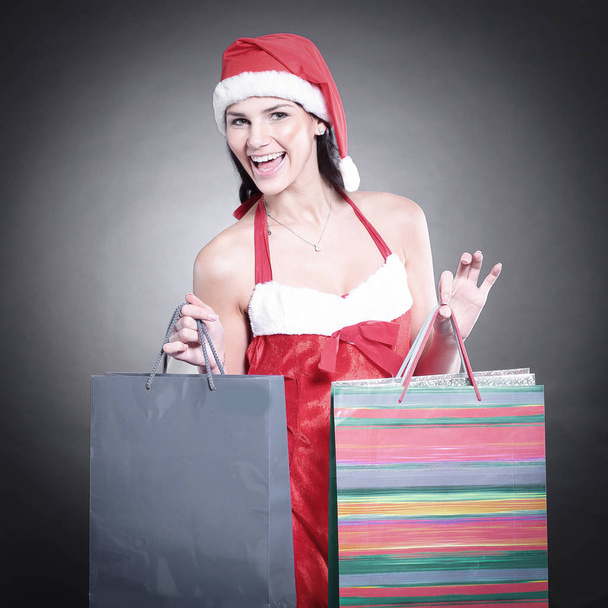 happy young woman dressed as Santa Claus with the Christmas shop - Φωτογραφία, εικόνα