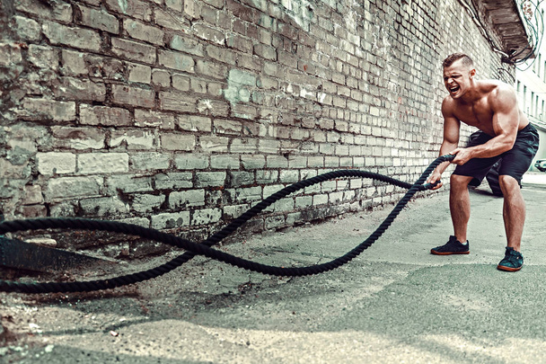 Men with rope, functional training - Foto, afbeelding