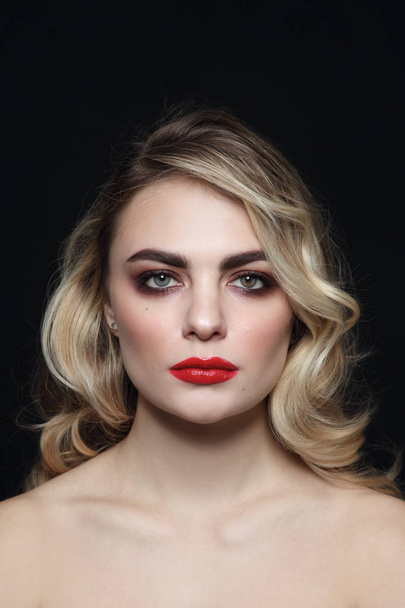 Young beautiful woman with blonde curly hair and red lipstick - 写真・画像