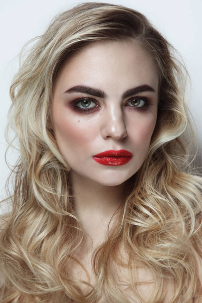 Young beautiful woman with blonde curly hair and red lipstick - Foto, imagen