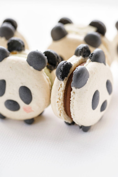 Delicious almond desserts in the form of Panda. French macaron cookies. - Foto, imagen