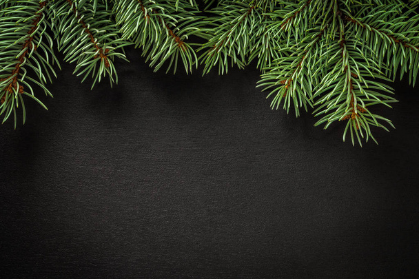 New Year`s black background. spruce branches on the table - Foto, Bild