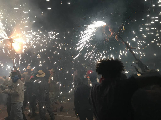 tradition party of mallorca, where the devil try to catch the people and burning them with fire and explosions - Photo, Image