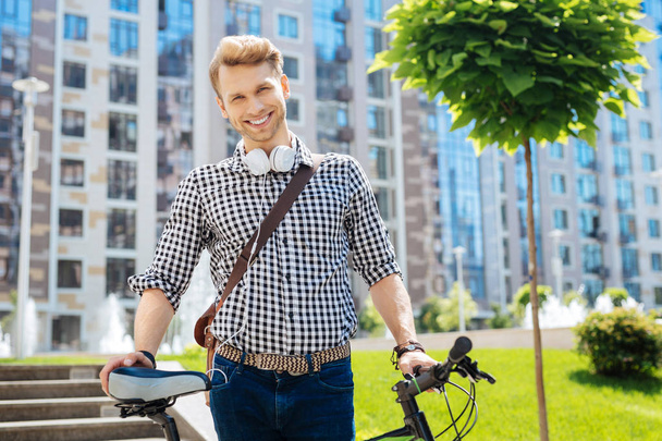 Pleasant nice man holding his bike - Foto, Imagem